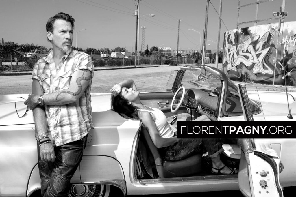 (Premium Pricing - DOUBLE RATES APPLY) Miami - February 2011 --- Florent Pagny and his wife Azucena. Attitude of Azucena in their Thunderbird. On the left arm of the singer, his tattoo fetish animal, the coral snake. (Photo by Sebastien Micke/Paris Match via Getty Images)
